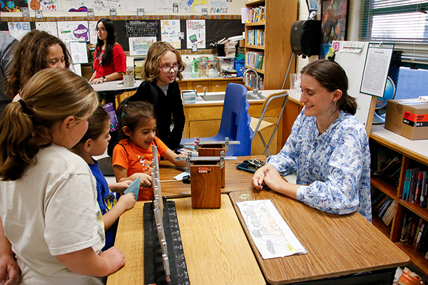 Students have fun playing with a display