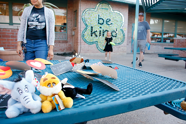 An outdoor table filled with small stuffed animals and other trinkets