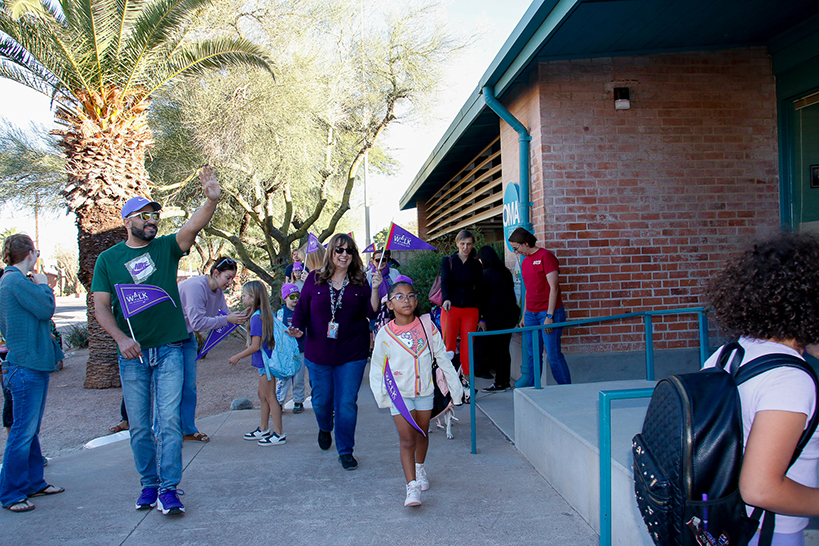 Students walk in front of the school for Ruby Bridges Day