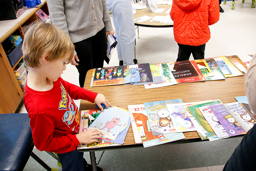 A little boy looks at comic books