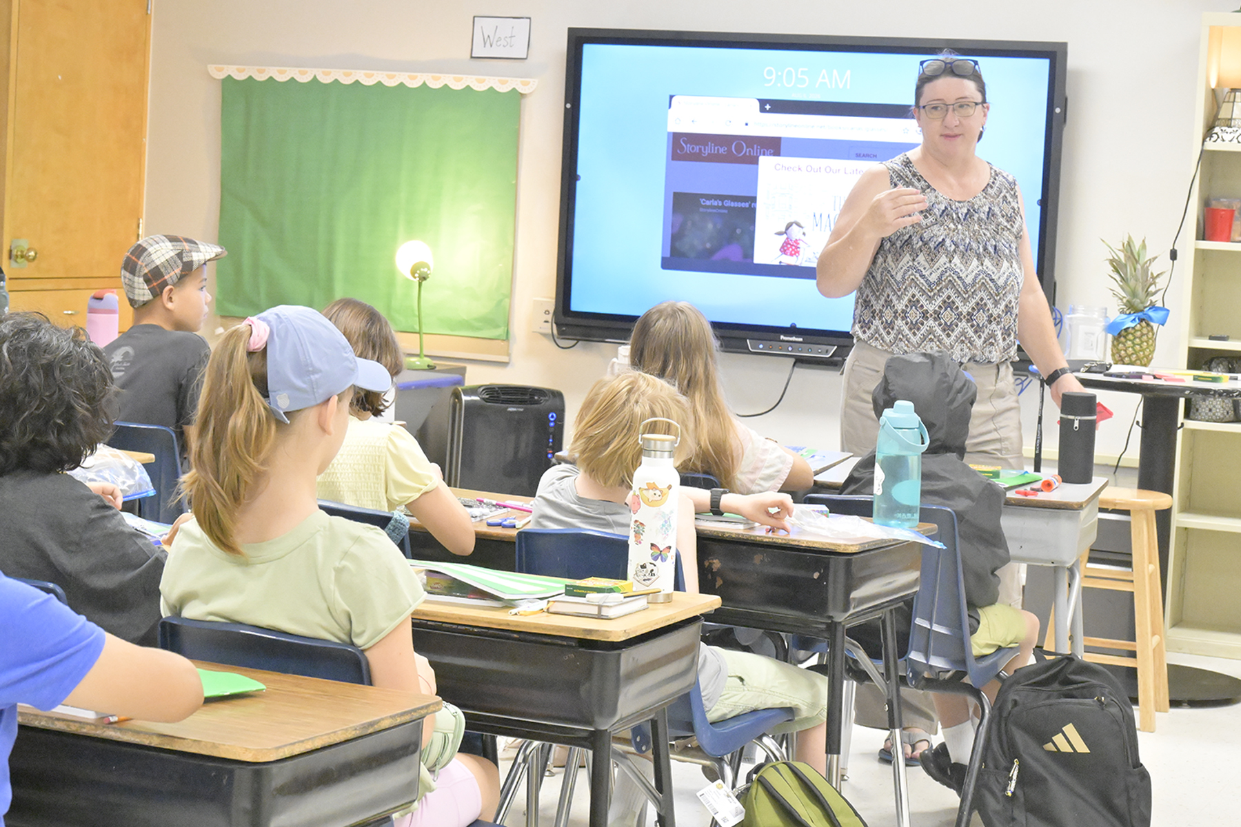 A teacher talks to her class on the first day