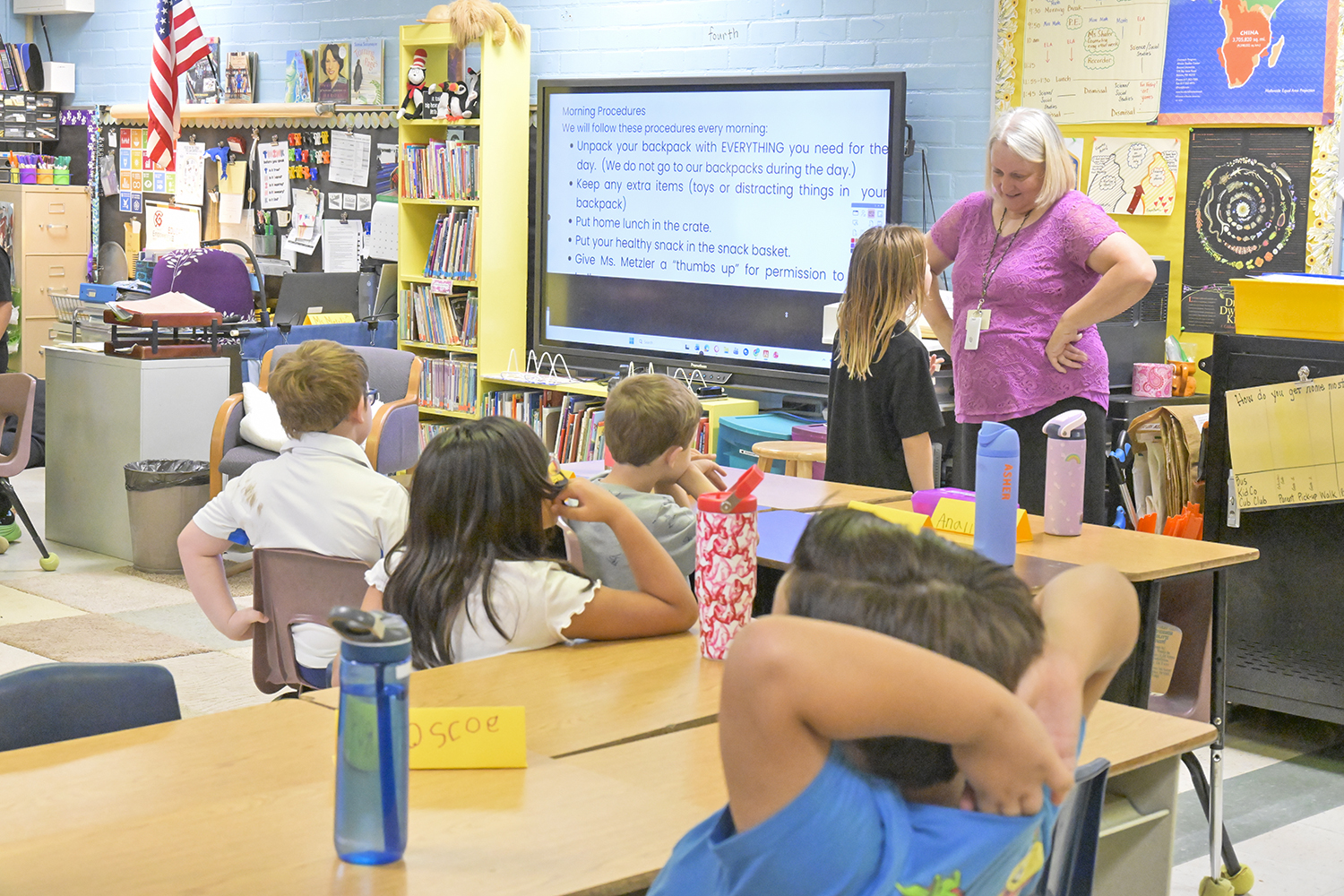 A teacher talks to her class